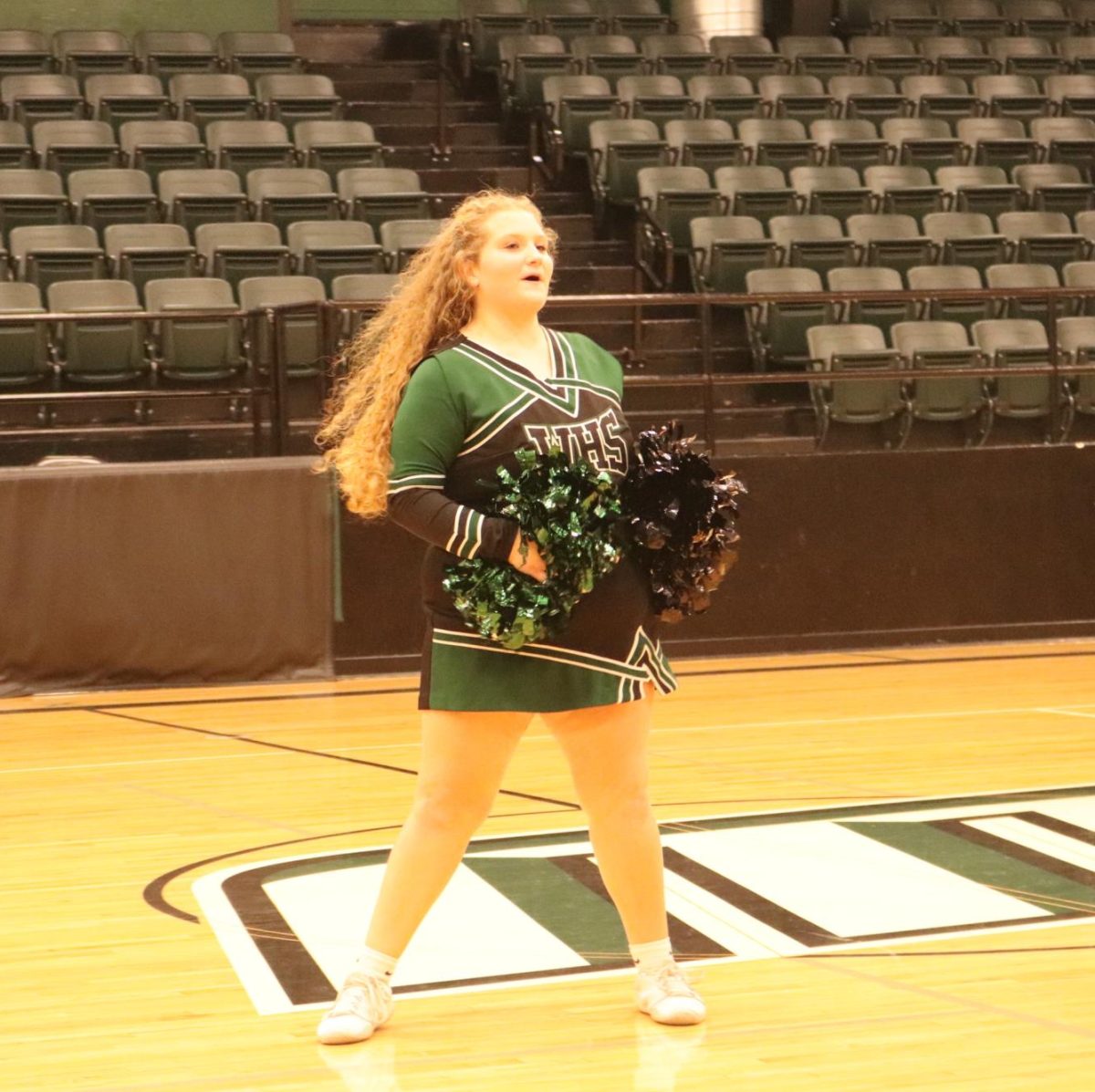 Freshman varsity cheerleader Abigail Burnham cheered for the district football assembly.