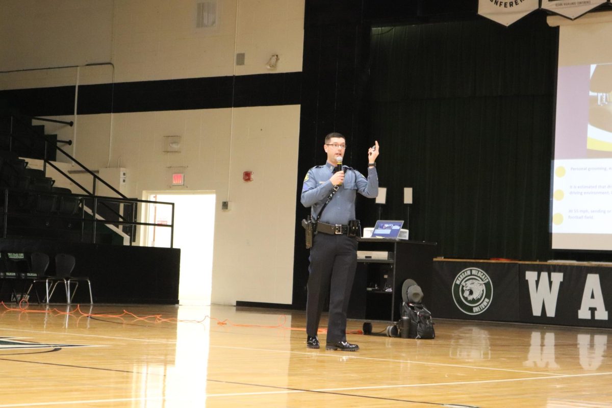 Missouri State Hwy Patrolman Justin Ewing speaks about safe driving and the importance of wearing a seat belt. during the Jan. 17 assembly.