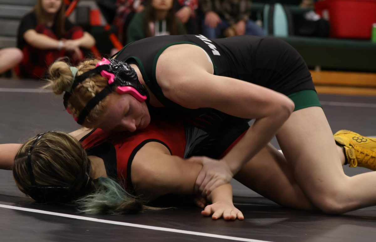 Some students share a new year goal relating to their sport, like juniors Brayden Henderson’s (below, left) goal to be in shape for track season,  Naomi Yoder’s (below) wrestling training, and senior Bradley Watson’s (left) goal to help his team win the district tournament in baseball.