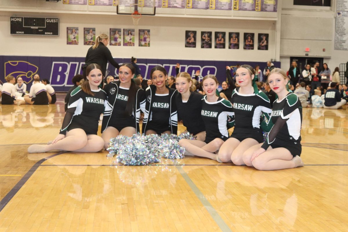 Seniors Madison Lawrence, Tatum Bohl, freshmen Addison Hill, Amelia Roberts, Macey Heimsoth, and sophomores Isabella Schwartz, and Lilyan Frye sit waiting for awards to be announced. The team got second in hip hop, fourth in poms, and freshman Amelia Roberts got second in her solo