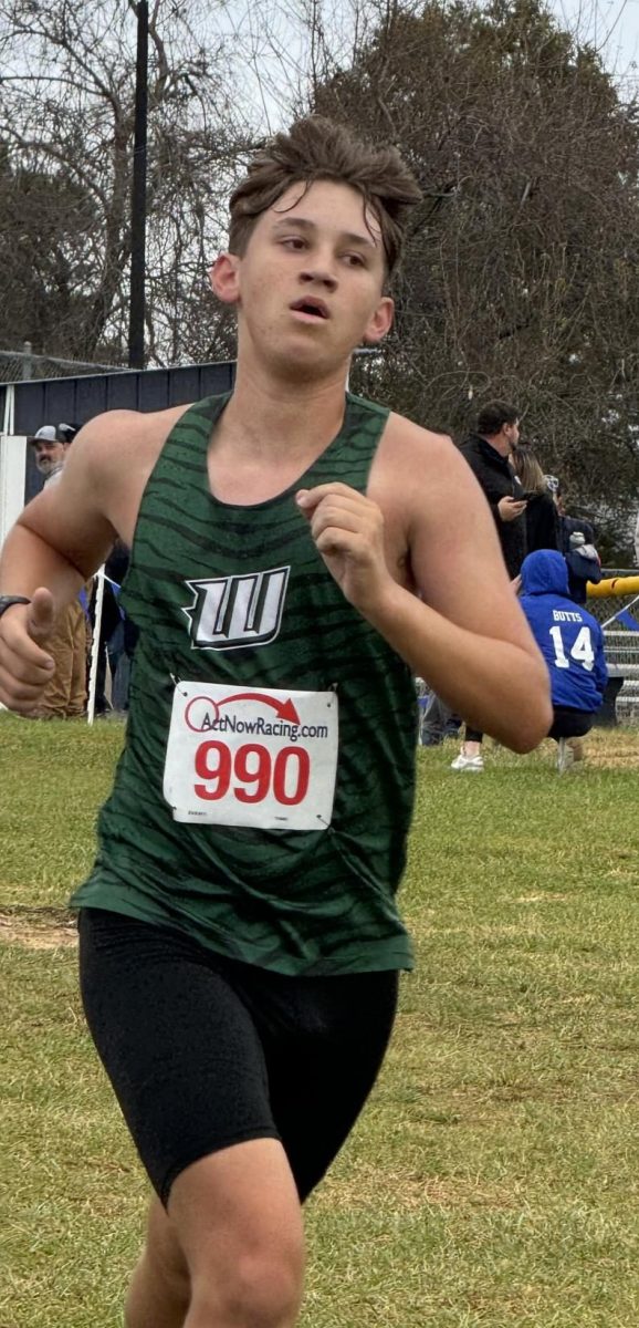 Some students share a new year goal relating to their sport, like juniors Brayden Henderson’s (below, left) goal to be in shape for track season,  Naomi Yoder’s (below) wrestling training, and senior Bradley Watson’s (left) goal to help his team win the district tournament in baseball.