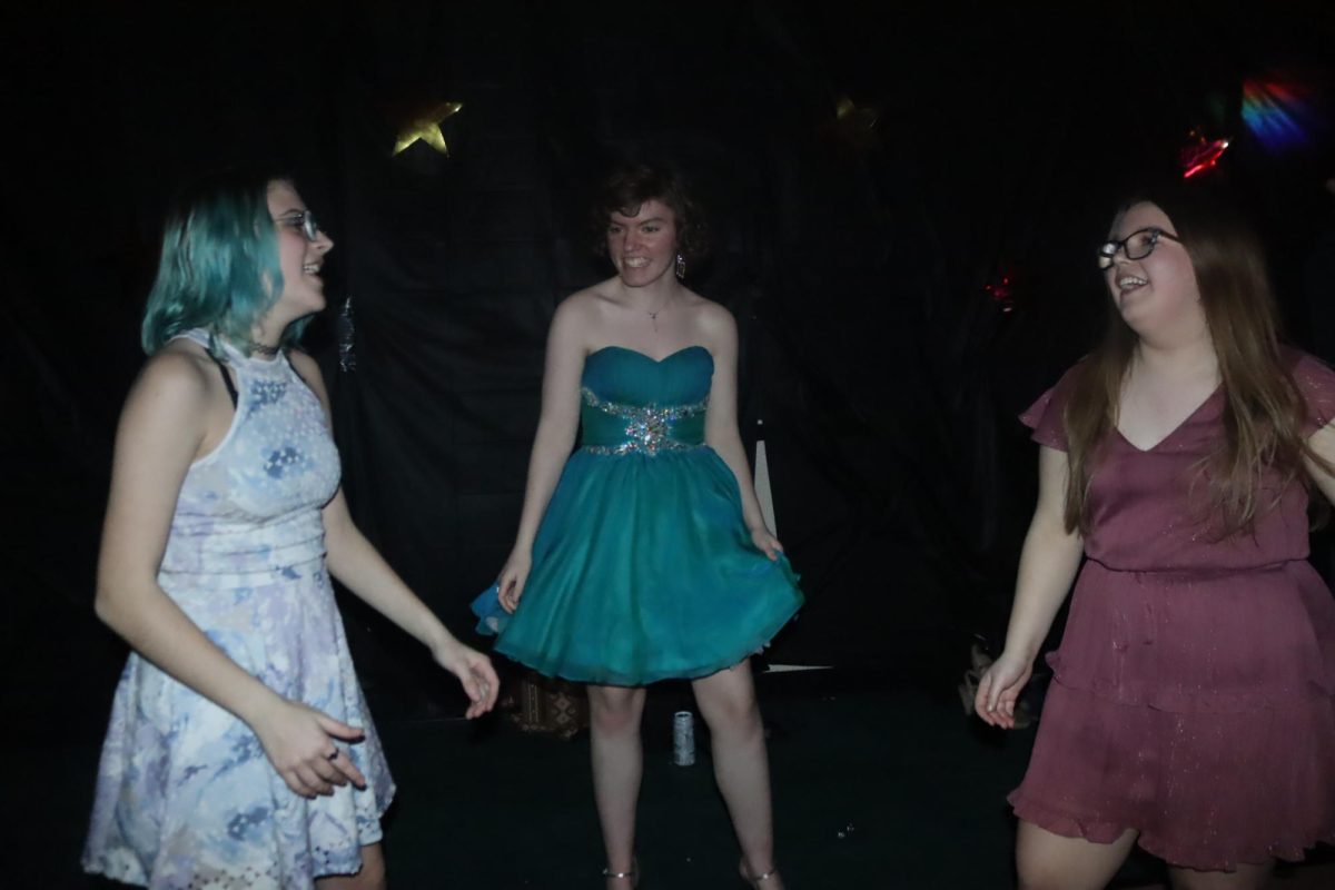 Senior Emma Binnie, junior Lilyann Valentine, and sophomore Jennifer Murdock dance to the music at Echoes. The music for the dance was provided by Quality Audio. 