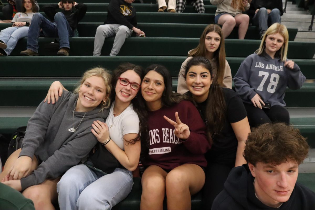 Juniors Kaleby Stevenson, Hailey Ferguson, Hazal Uelker, and sophomore Sara Miller pose during the Courtwarming assembly. “The assembly was very exciting and entertaining,” Miller said. 