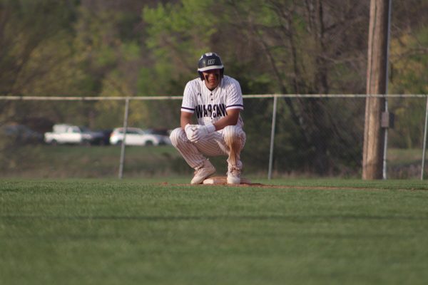 Senior center fielder Jayce Depriest takes a squat down after safely making it to second base on April 14 against Buffalo. The Wildcats won 14-3.