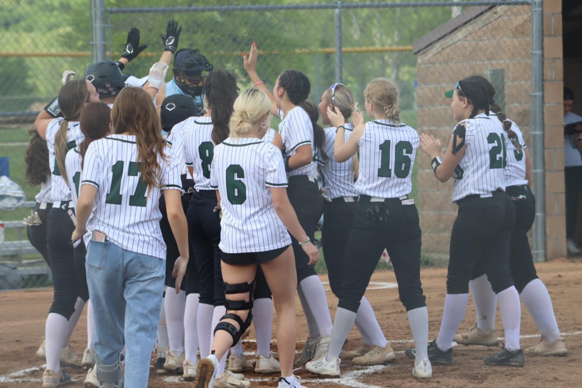 Lady Cats celebrate senior Brylee Brewster’s home run in the third inning against Cole Camp. The team won against Cole Camp, 13-0.