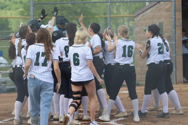 Lady Cats celebrate senior Brylee Brewster’s home run in the third inning against Cole Camp. The team won against Cole Camp, 13-0.