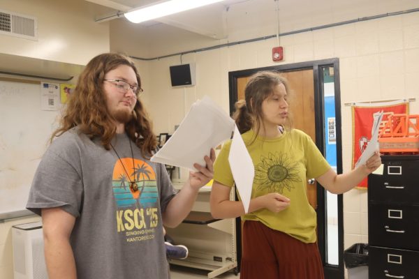 Seniors Dillan Ellison ("Adam Oakhart") and Aleah Minks ("Nellie Lovelace") read through lines for the upcoming play, "Dirty Work at the Crossroads." All students in the drama class are involved in the production n Nv. 22-23.