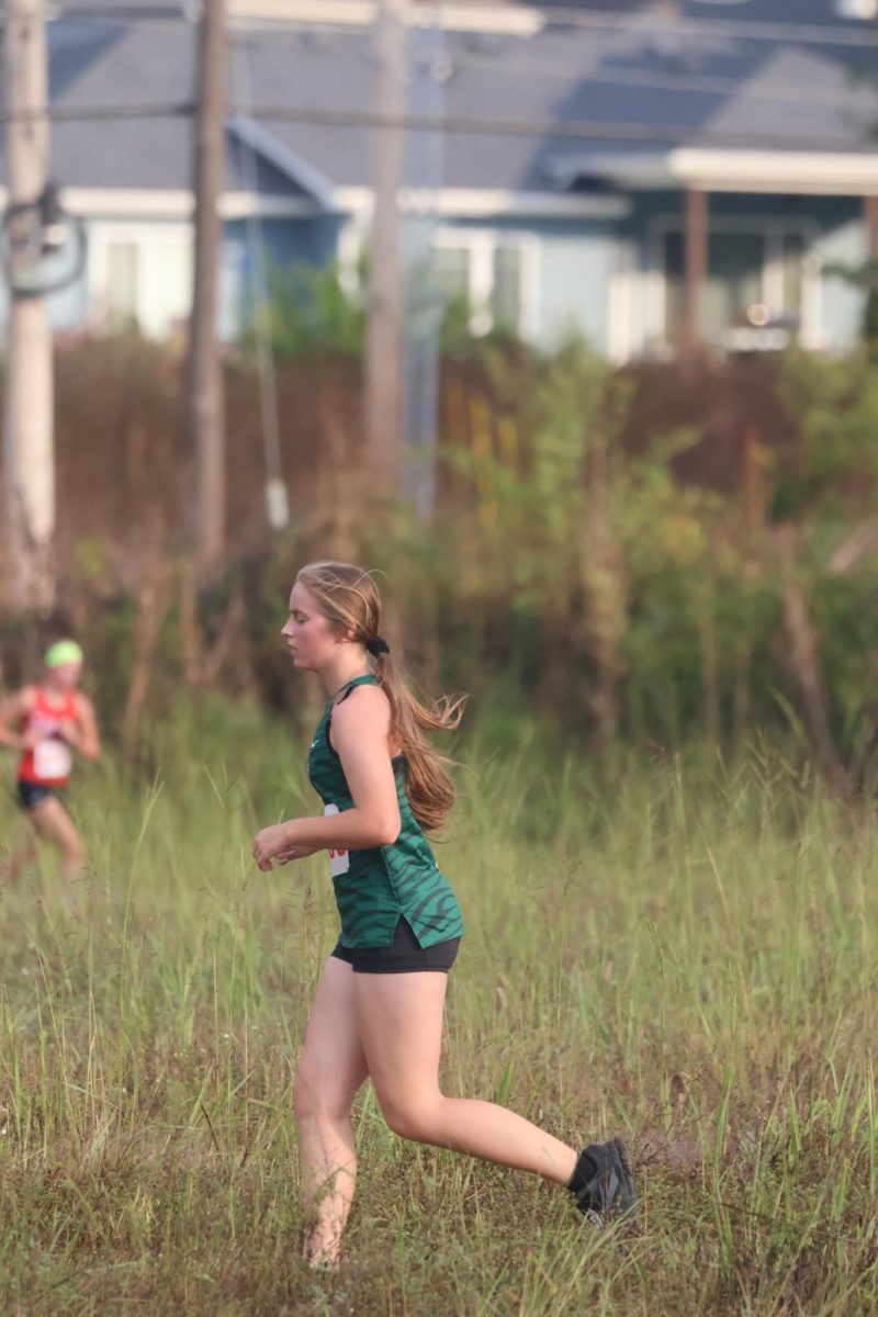 Junior Jasmin Myers runs in the Smith-Cotton meet. Myers time was 27.42