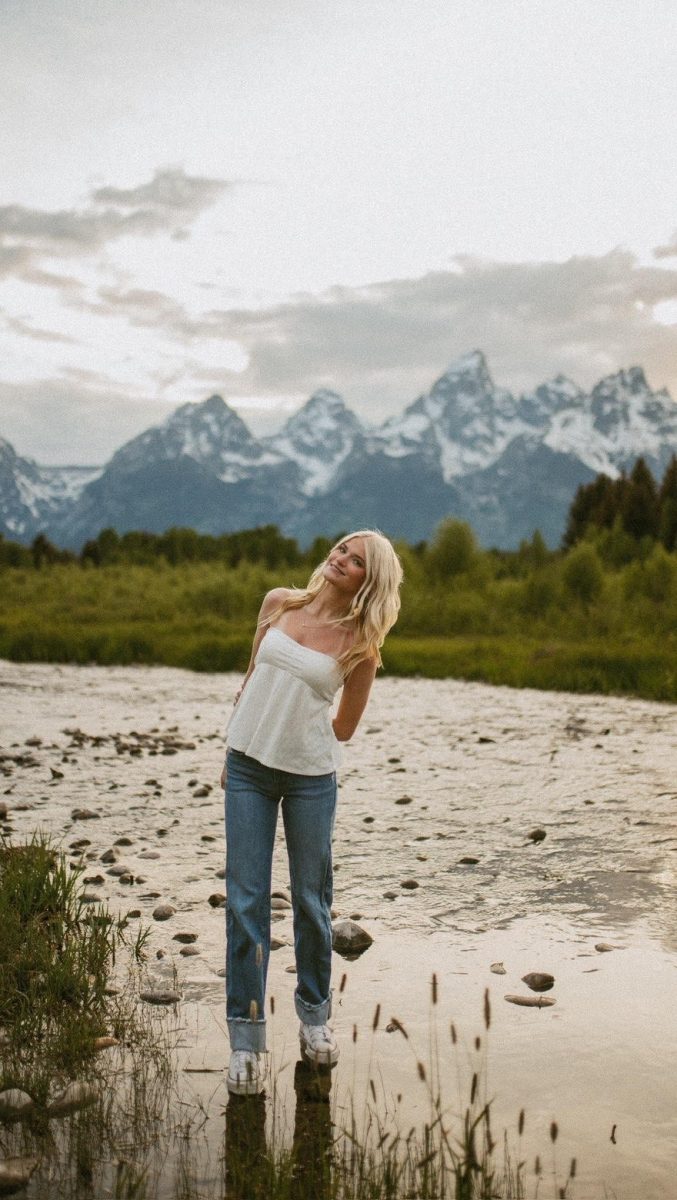 Senior Adison Sherrill poses for her senior pictures with a beautiful mountain view background. Sherrill traveled to Wyoming to take her senior pictures. 