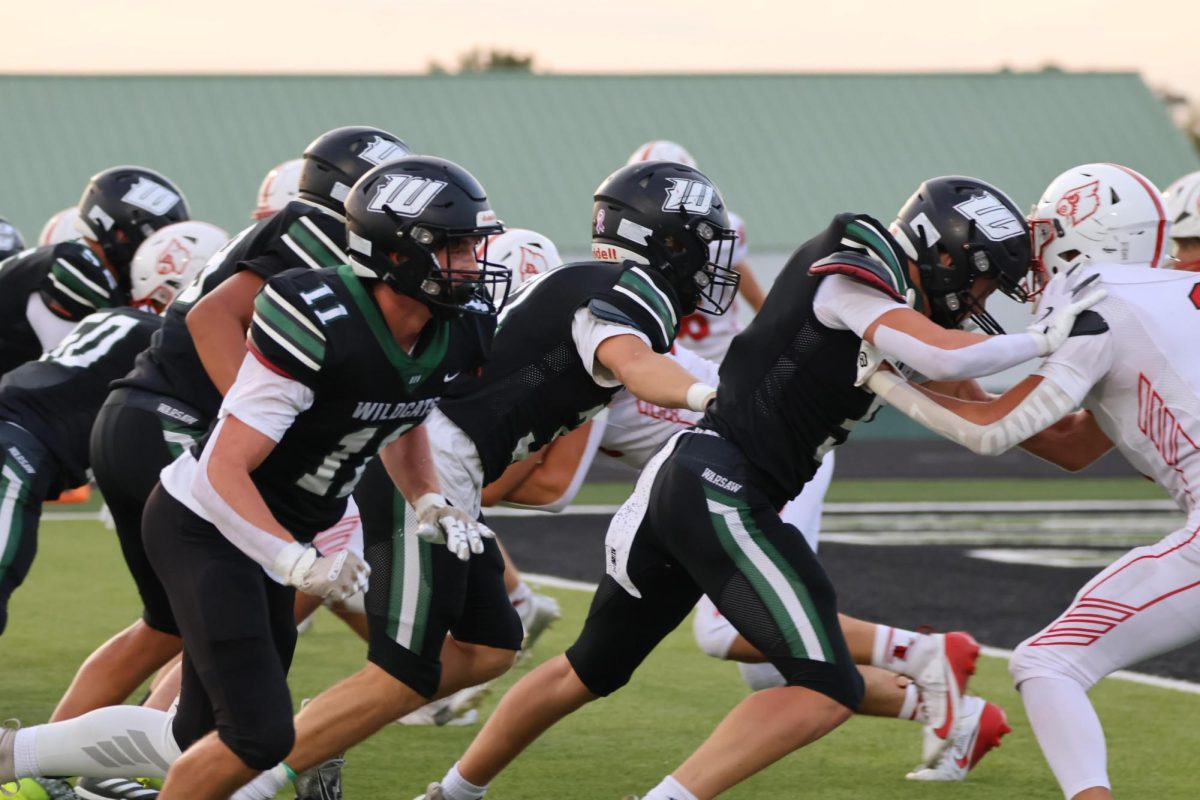 Senior Brennen Slavens blocks a Cardinal on August 29. “The game against Lawson was a great start and we all really came together to start the season off strong,” Slavens said. 