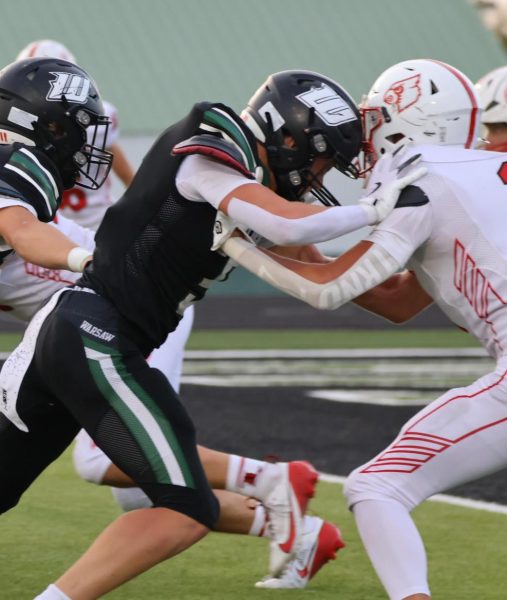 Senior Brennen Slavens blocks a Cardinal on August 29. “The game against Lawson was a great start and we all really came together to start the season off strong,” Slavens said. 