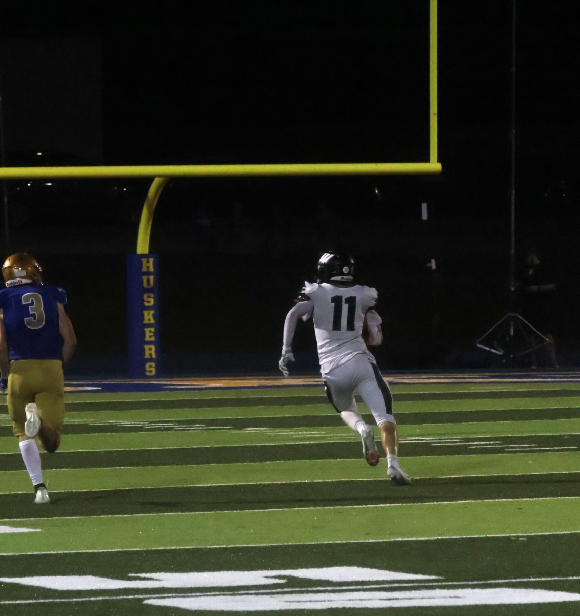 Above, right: Senior Luke Henderson runs with the ball against Higginsville. Henderson plays wide receiver for the Wildcats. 