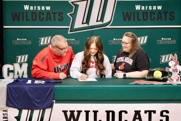 Senior Tanna Howe signs her letter of intent along-side her parents Adam and Melissa Howe during her signing day on Nov. 14. Howe’s parents have always been huge supporters of all her hard work and success. 