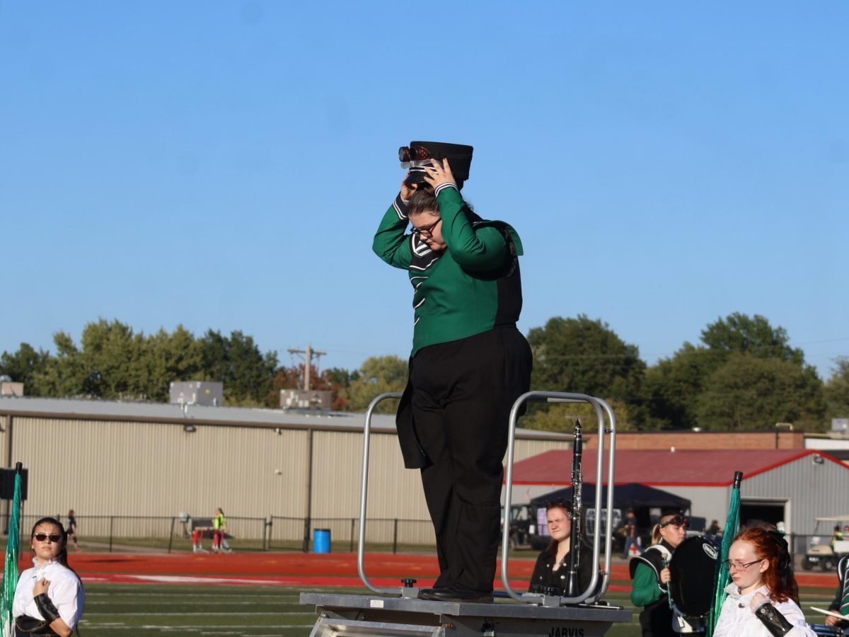 Senior drum major Hayley Case prepares to lead the marching band in a filed show contest last fall. Case said one of her roles in high school was as a leader and role model in band.