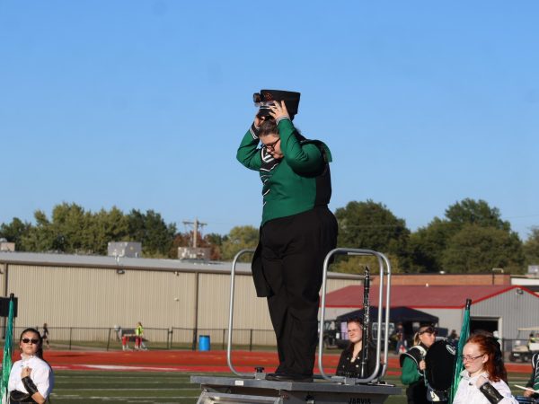 Senior drum major Hayley Case prepares to lead the marching band in a filed show contest last fall. Case said one of her roles in high school was as a leader and role model in band.